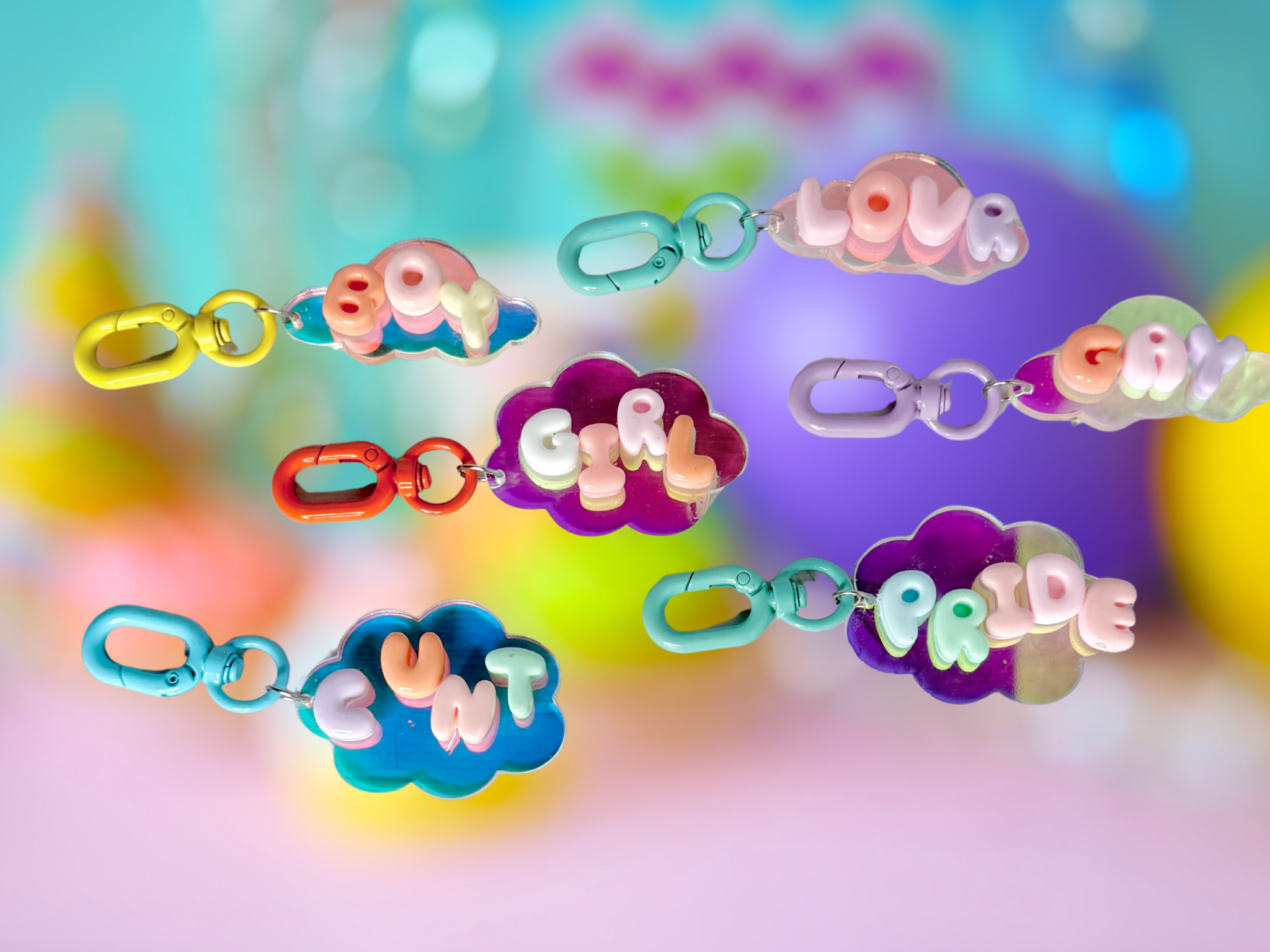Iridescent bubble letter cloud keychain from Adorrible featuring shiny, colorful cloud-shaped design and a metal keyring attachment.