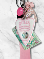 Adorrible Ouija Board keychain with wristlet and spooky charms, featuring a small Ouija board pendant and decorative charms.