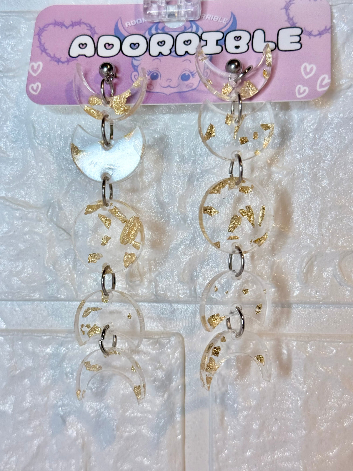 Adorrible moon phases earrings featuring silver crescent moon and full moon charms on delicate hooks.