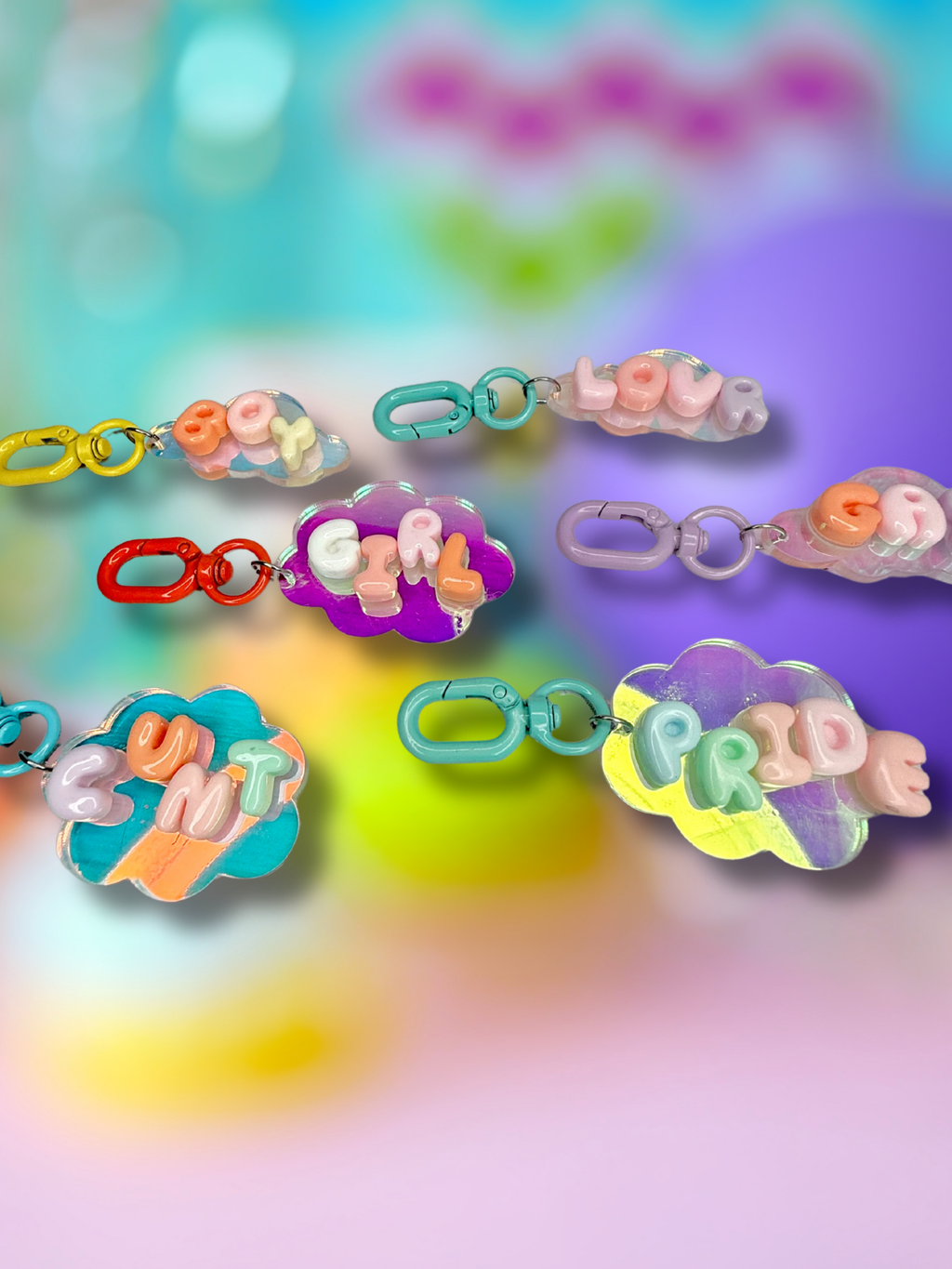 Iridescent cloud-shaped keychain with bubble letter design by Adorrible, featuring shiny, colorful accents and a keyring attachment.