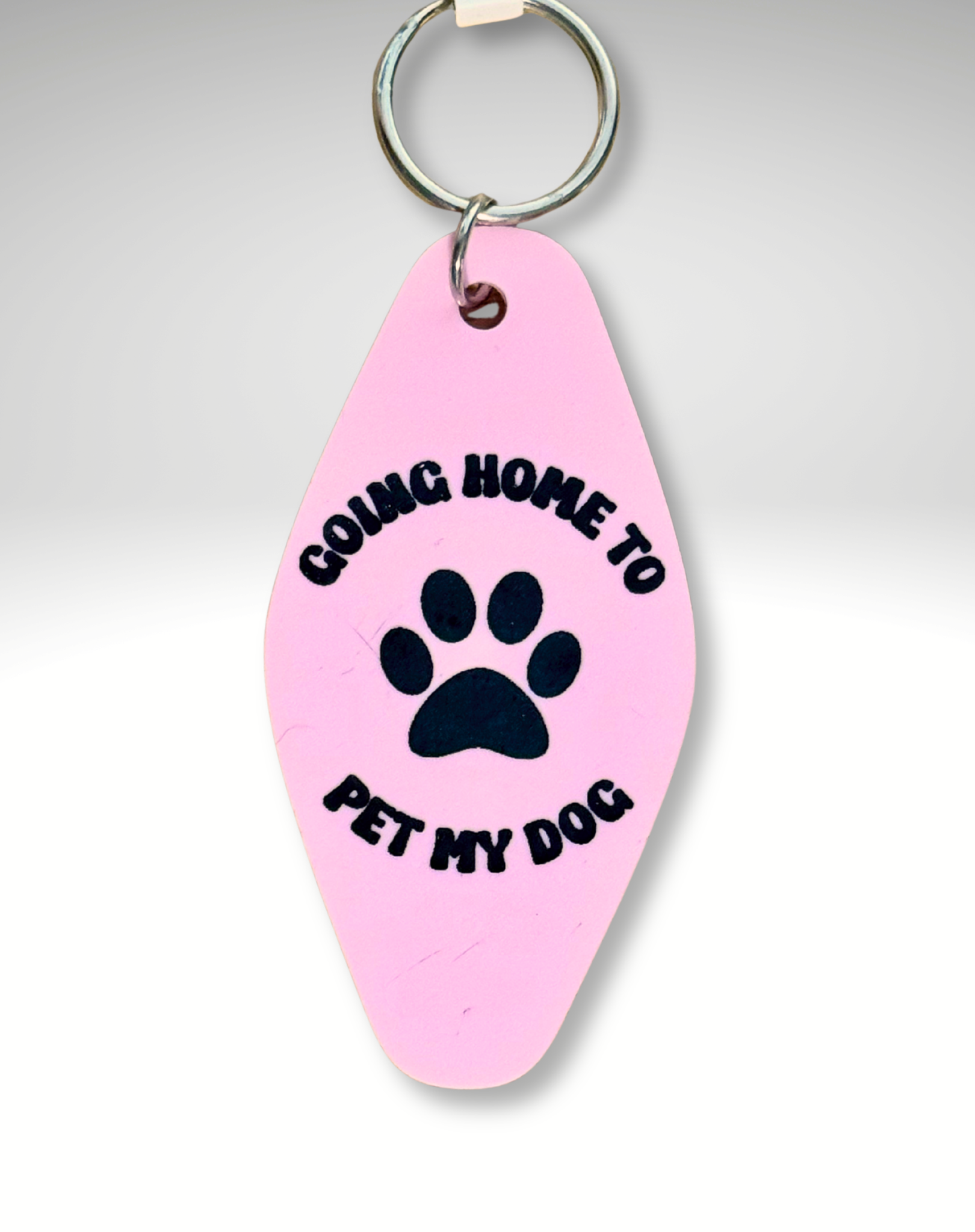 Adorrible Dog Lover Motel keychains featuring cute dog illustrations on metal key rings with hotel-themed designs.