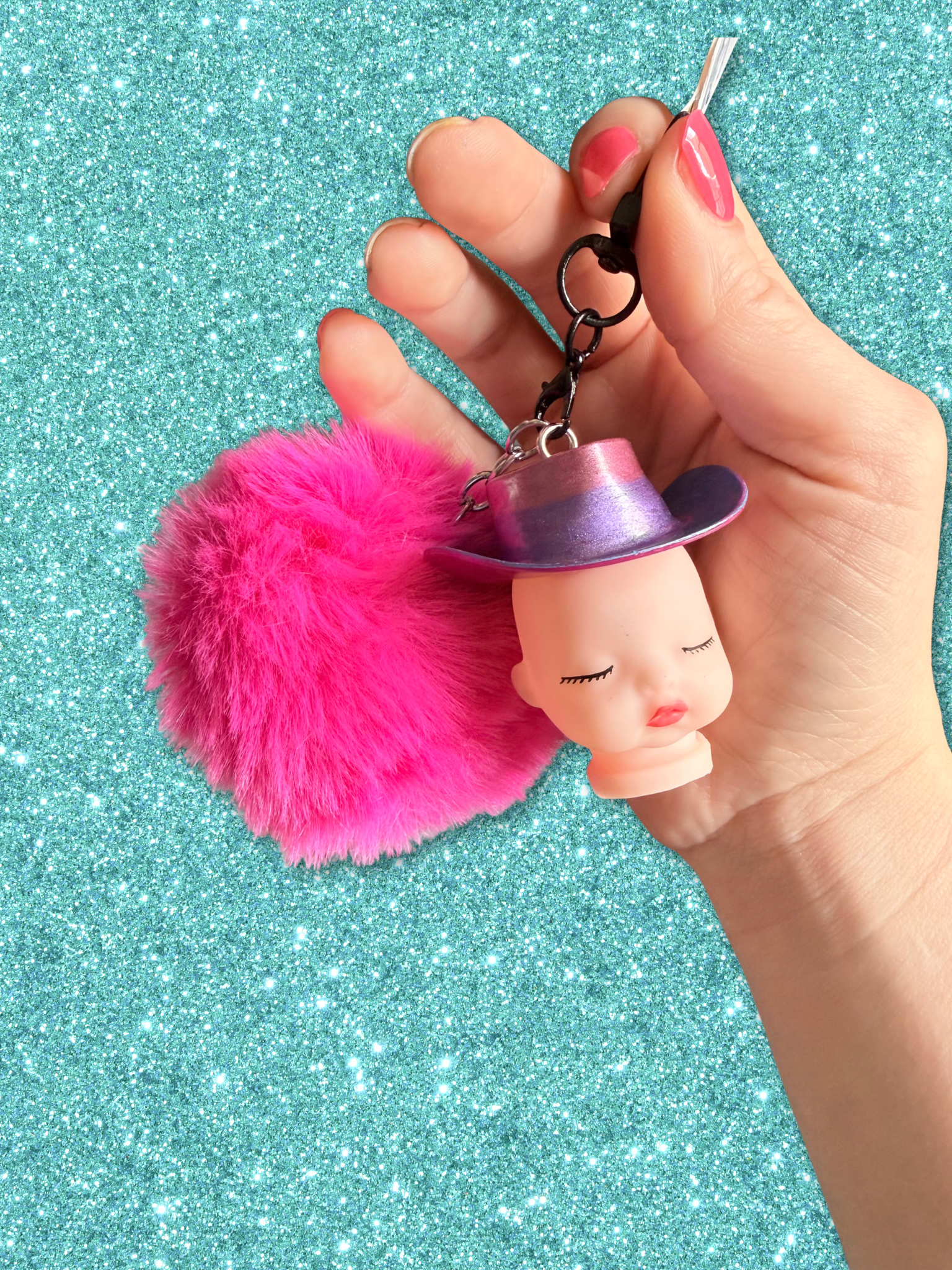 Adorrible Pride cowboy hat baby doll head keychain with colorful hat and detailed facial features, ideal for accessories.