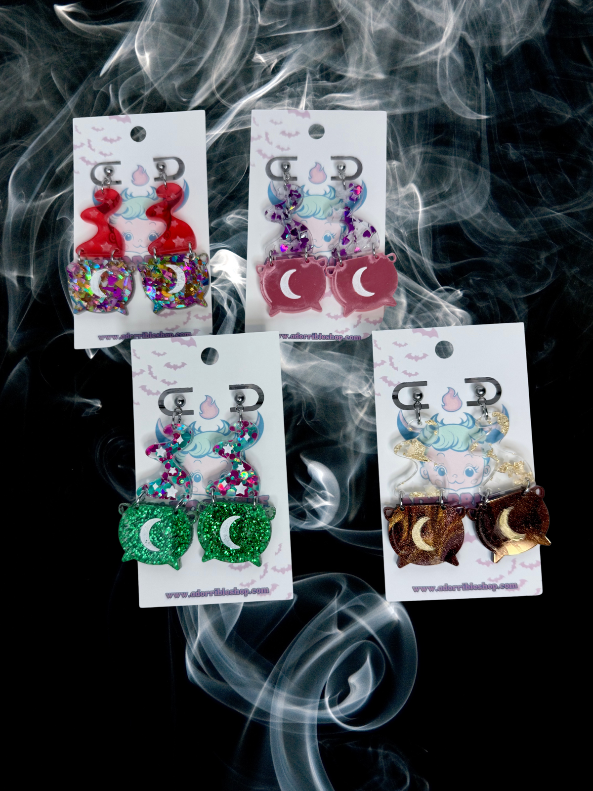 Adorrible Witch’s Cauldron earrings with black cauldron charms hanging from silver hooks, detailed and mystical jewelry design.