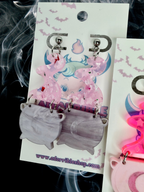 Adorrible witch’s cauldron earrings featuring small black cast iron cauldrons with lid charms, perfect for witchcraft-inspired jewelry.