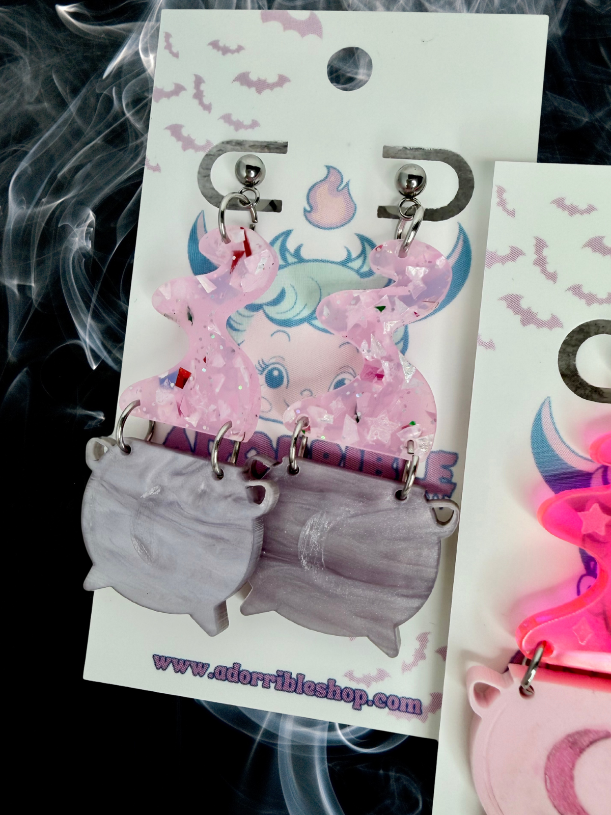 Adorrible witch’s cauldron earrings featuring small black cast iron cauldrons with lid charms, perfect for witchcraft-inspired jewelry.