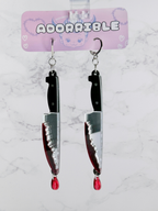 Layered Bloody Knife Dangle Earrings by Adorrible featuring dagger-shaped charms with detailed blood-red accents.