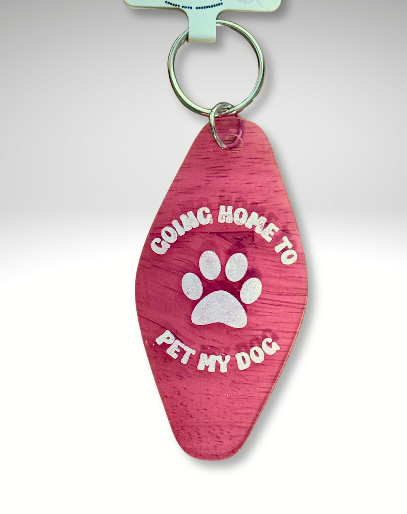 Adorrible dog lover motel keychain with a cute dog illustration and metal keyring on a white background.