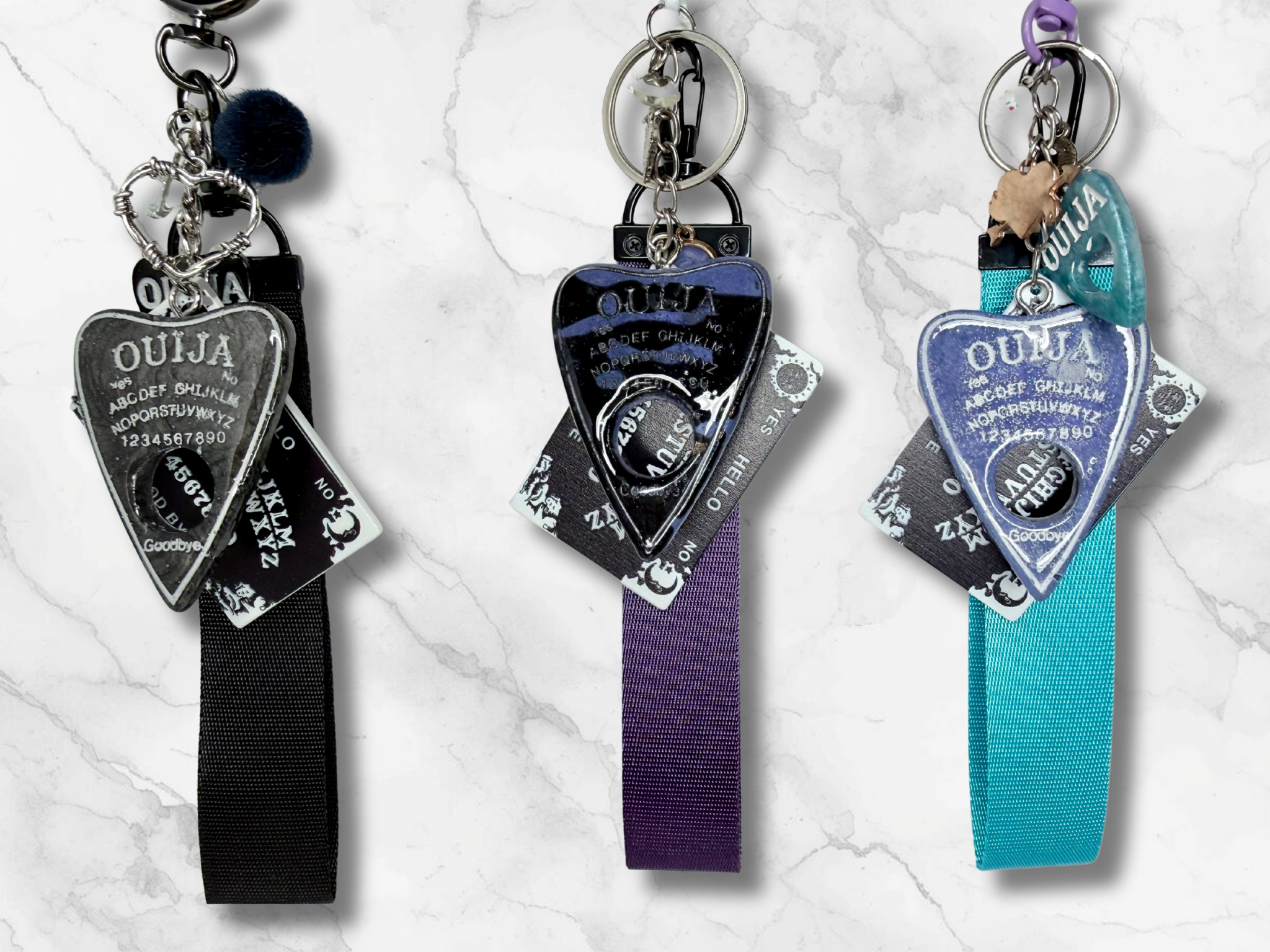 Adorrible Ouija Board keychain with wristlet and spooky charms, featuring a miniature Ouija board design and themed accessories.