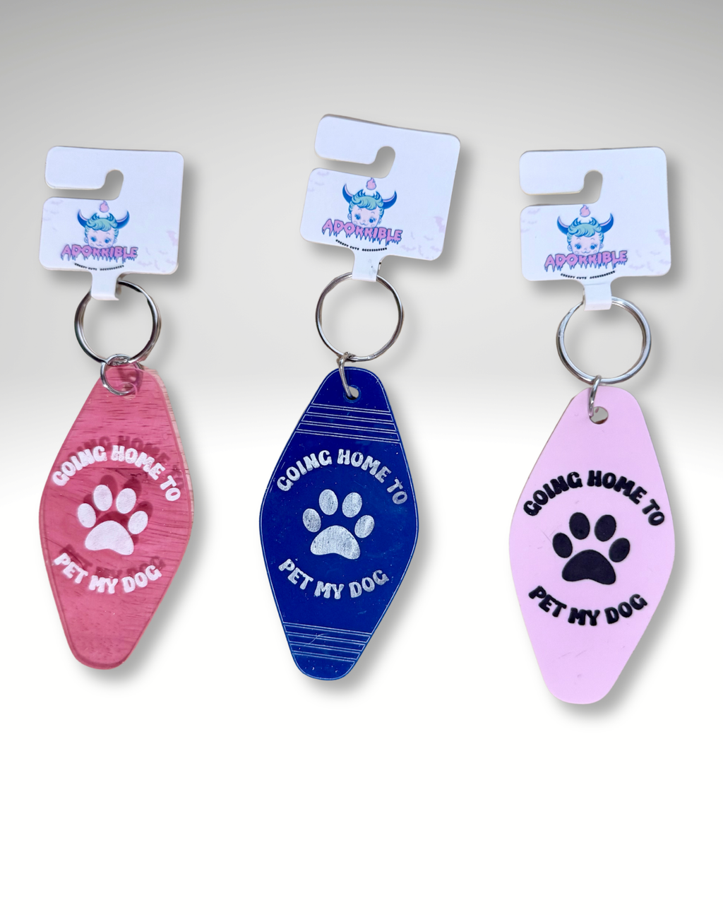 Adorrible dog lover motel keychain featuring a cute dog illustration on a metal keyring.