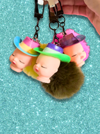 Adorrible Pride cowboy hat baby doll head keychain with colorful cowboy hat and detailed doll face on a silver keyring