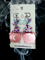 Adorrible witch’s cauldron earrings featuring small, detailed black cauldrons with bubbling potion designs on silver hooks.