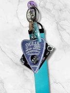 Adorrible Ouija Board keychain with wristlet and spooky charms, featuring a miniature Ouija board design and decorative accessories.