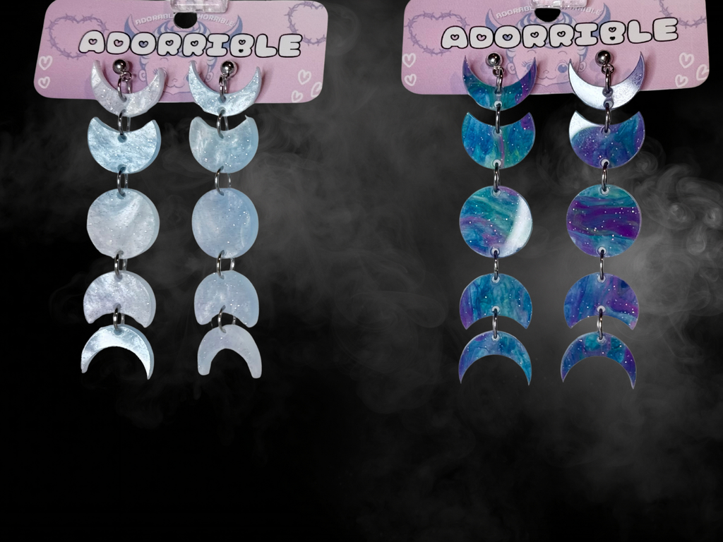 Silver moon phases earrings by Adorrible featuring a celestial design with crescent and full moon shapes.