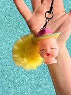Adorrible Pride cowboy hat baby doll head keychain showing detailed doll face and colorful cowboy hat accessory.