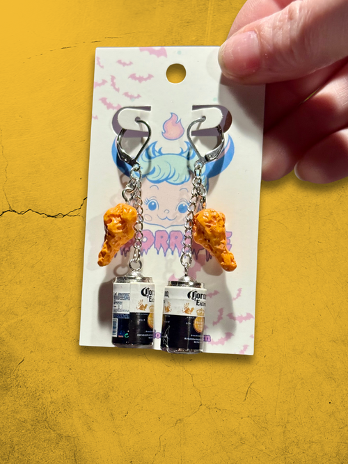 Quirky chicken earrings paired perfectly with a refreshing beer for fun and unique style