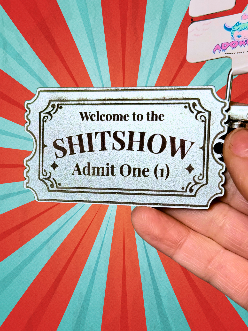 Adorrible Shitshow keychain with humorous design, featuring a small, lightweight accessory with bold lettering and colorful accents.