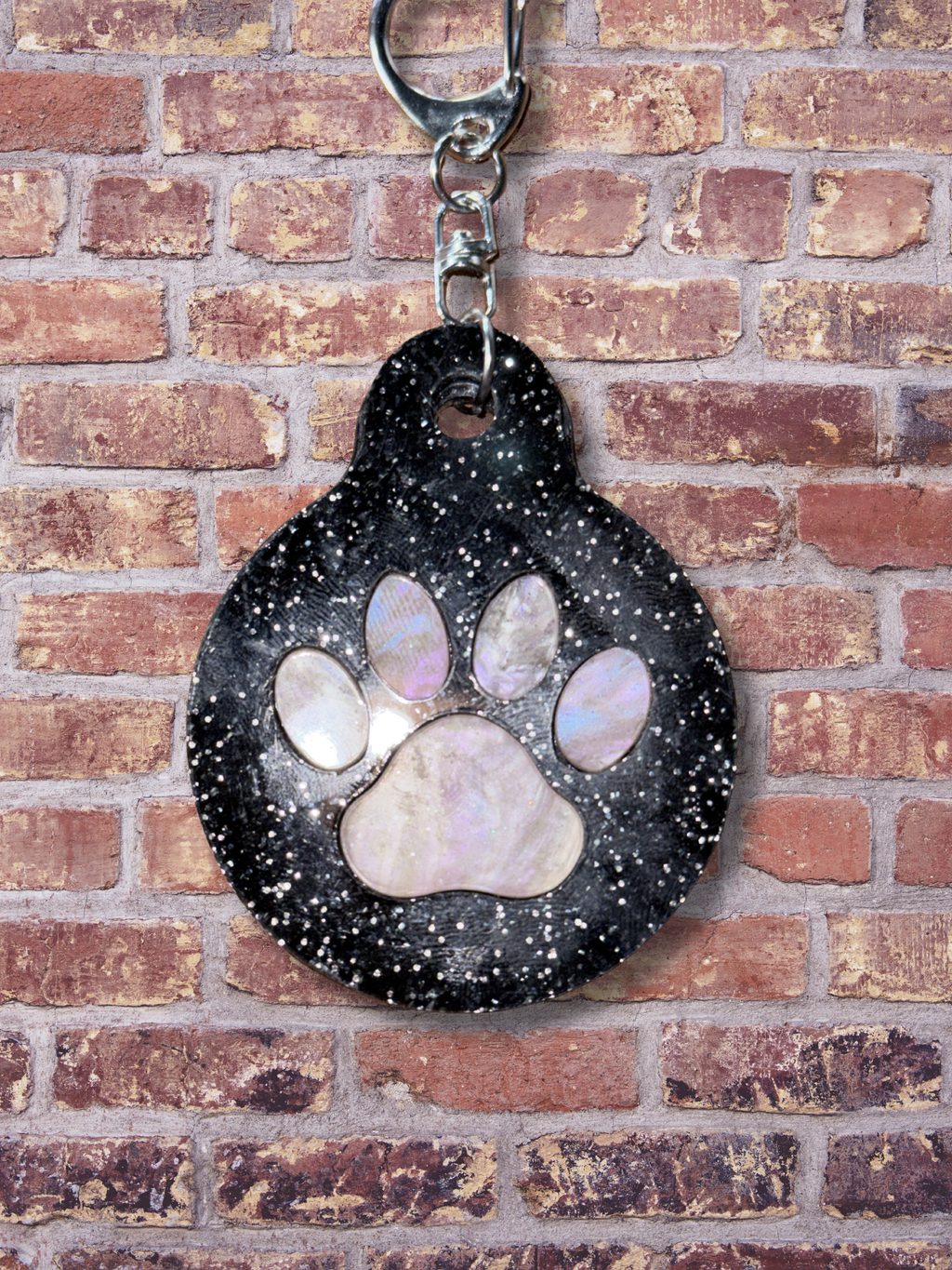 Adorrible paw keychain featuring a cute paw print design on a metal keyring. Perfect for accessories and key organization.