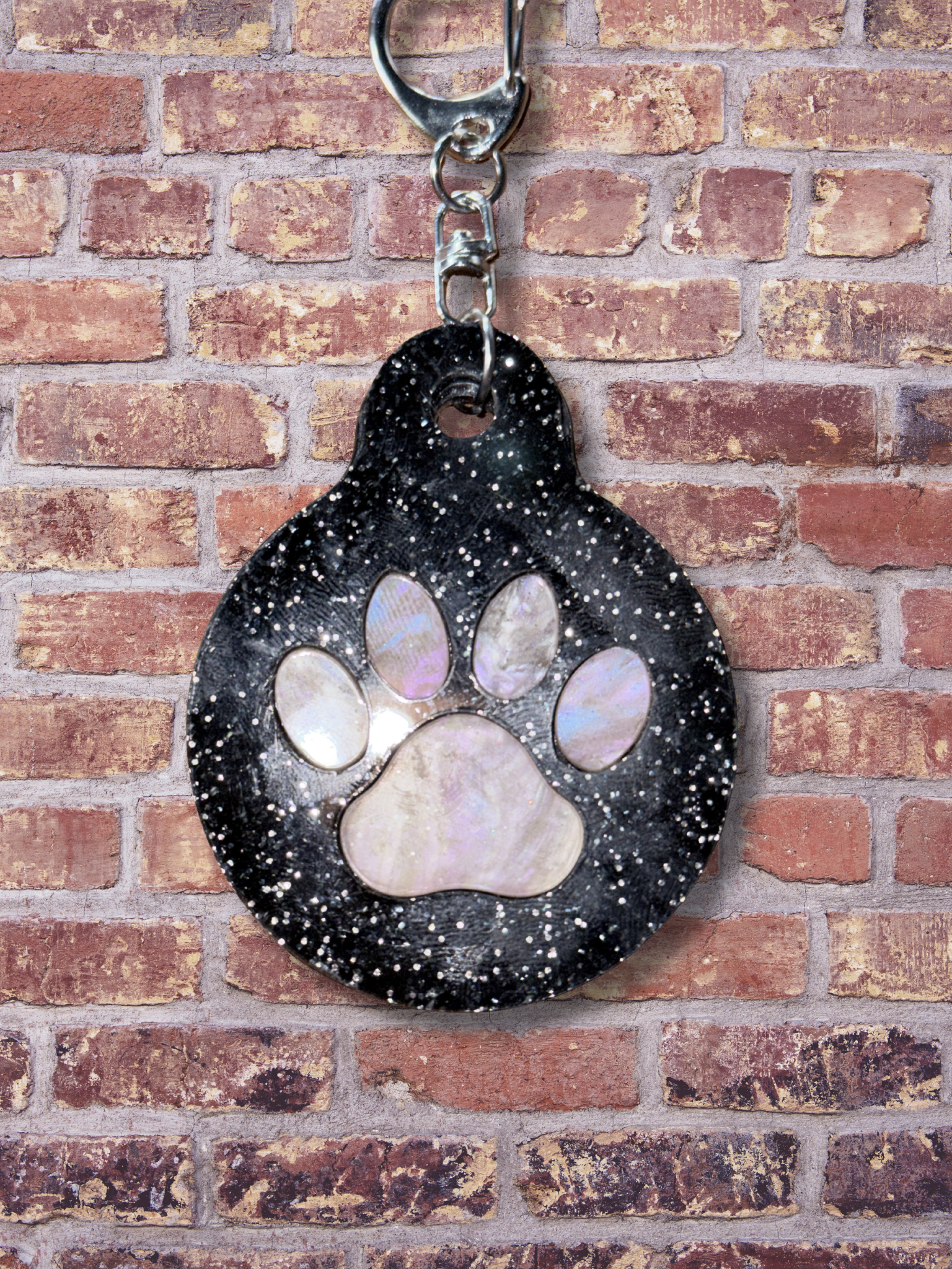 Adorrible paw keychain featuring a cute paw print design on a metal keyring. Perfect for accessories and key organization.