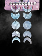 Silver Moon Phases earrings by Adorrible featuring a celestial design with moon phase symbols and a secure hook clasp.