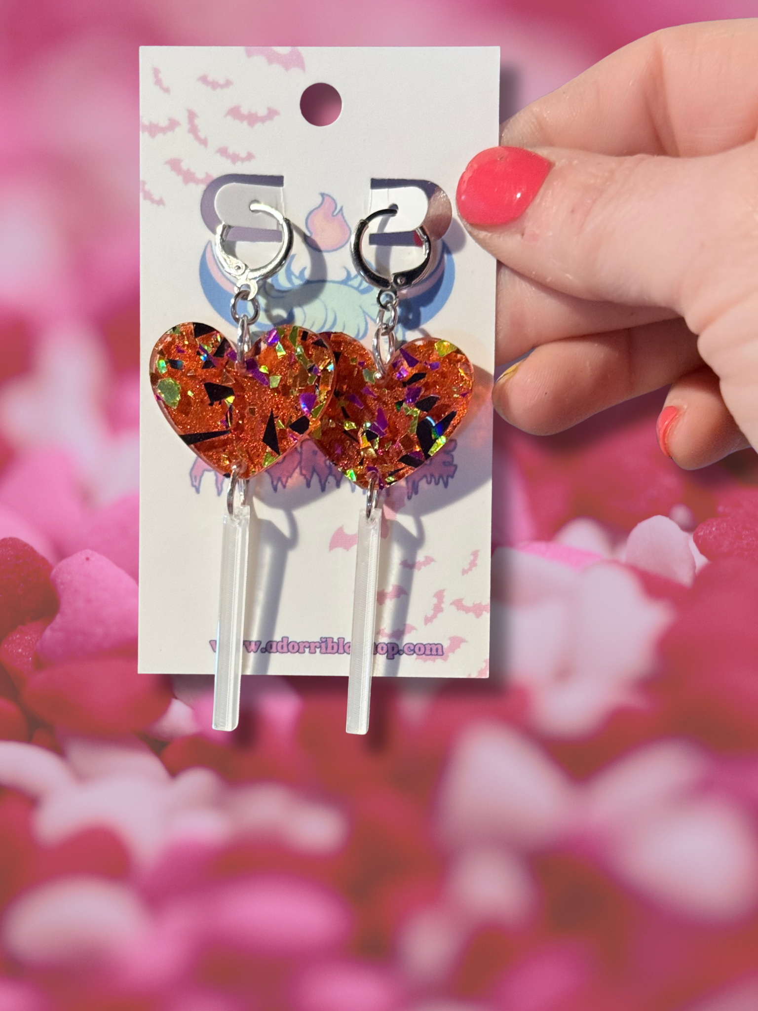 Adorrible heart-shaped acrylic dangle earrings featuring vibrant red heart lollipop design with gold-tone hooks.