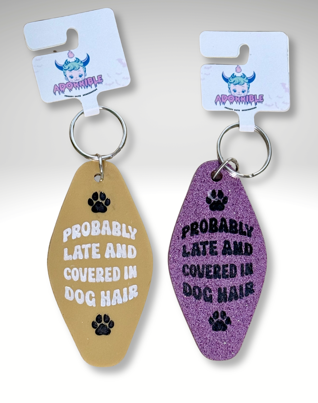 Adorrible dog lover motel keychain with a cute dog design, featuring a small metal ring and detailed paw print charm.