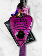 Adorrible Ouija Board keychain with wristlet and spooky charms, featuring a black Ouija planchette and charms for a spooky accessory.