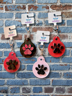 Adorrible paw keychain with a cute paw print design, metal keyring, and compact size for holding keys or accessories.