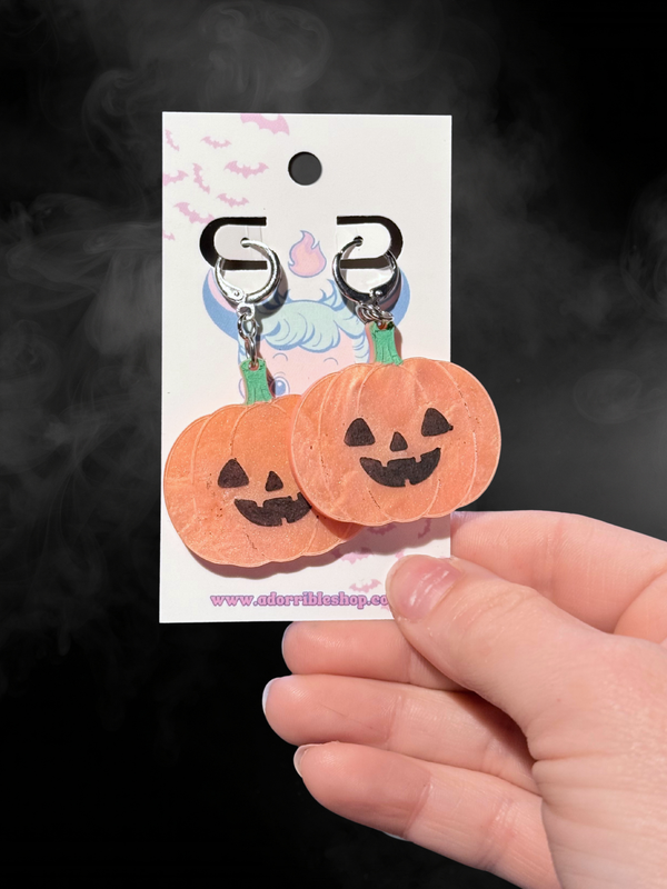 Adorrible Jack O Lantern earrings featuring orange and black pumpkin designs on silver hooks.