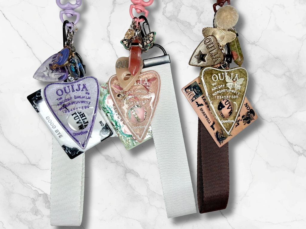 Adorrible Ouija Board keychain with wristlet and spooky charms, featuring a playful design and detailed occult symbols.