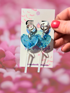 Adorrible heart-shaped acrylic dangle earrings with gold-tone hooks, featuring vibrant red and pink heart designs.