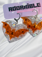 Adorrible Batty Heart earrings featuring black bat and red heart charms hanging from silver hooks.