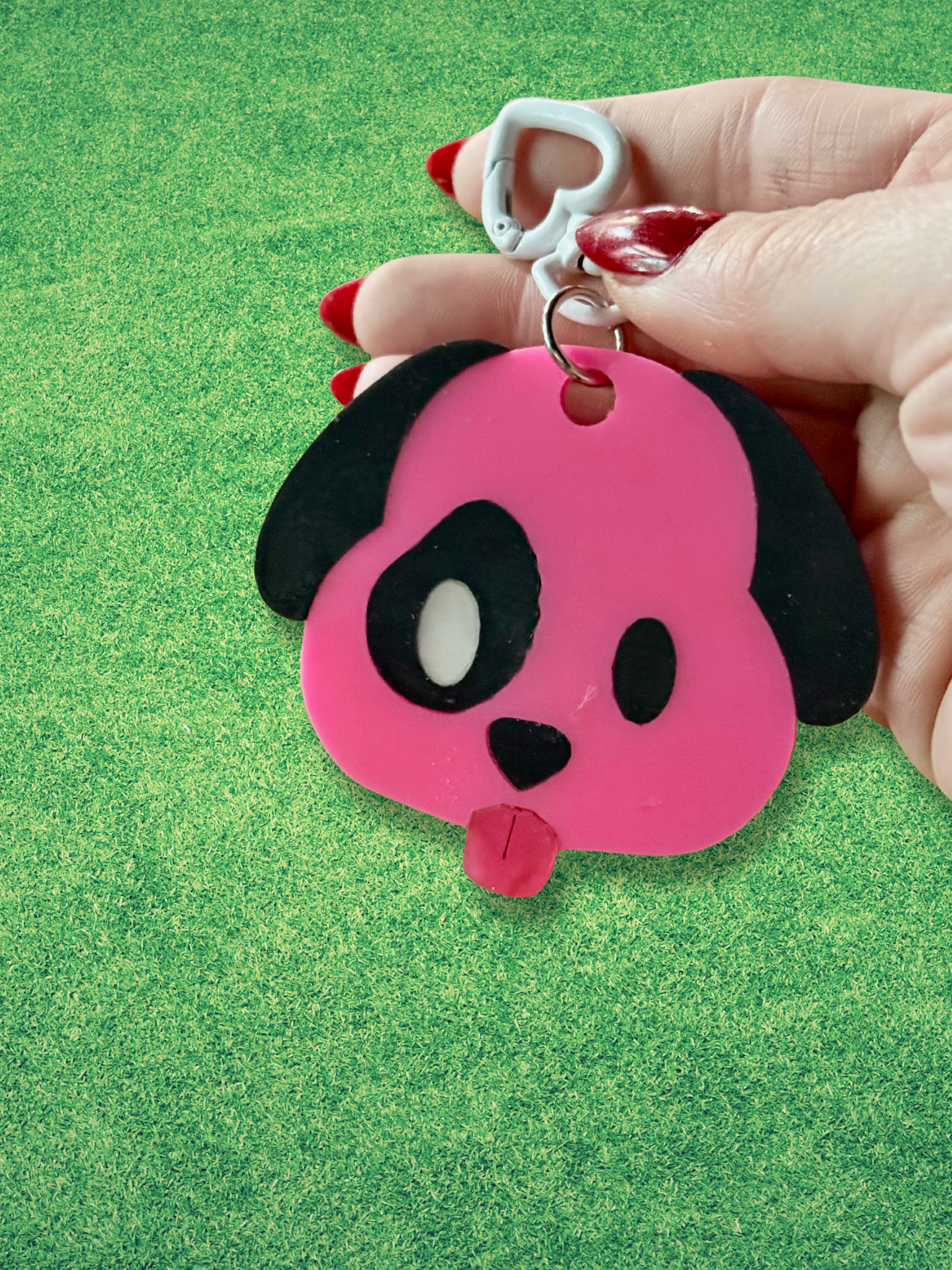 Colorful emoji dog keychain by Adorrible featuring a playful cartoon dog face with emoji expressions, attached to a metal keyring.