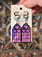 Adorrible Cathedral of Love acrylic dangle earrings with colorful, intricate design hanging from silver hooks.