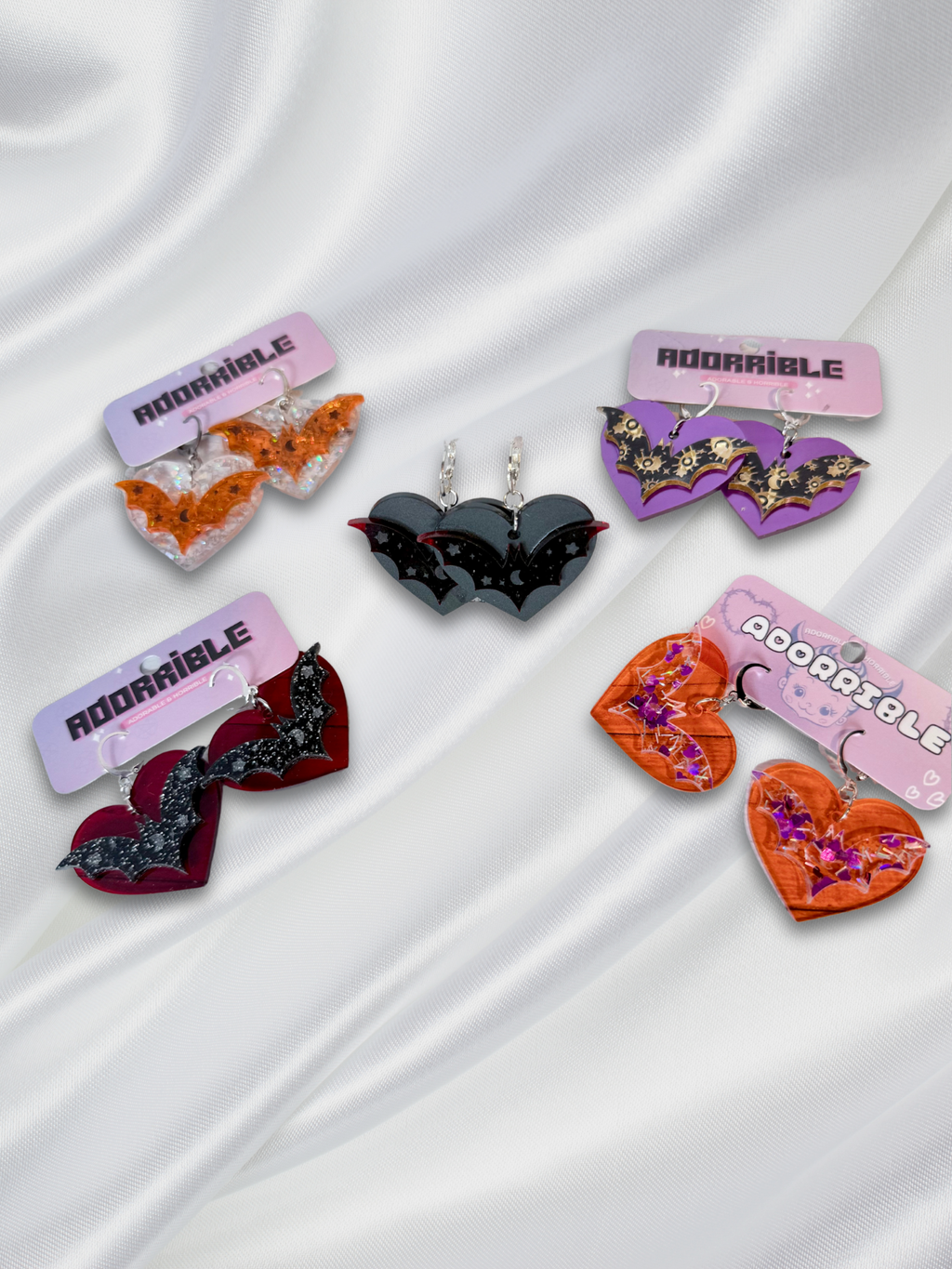 Adorrible Batty Heart earrings featuring black bat and heart design, silver hooks, perfect for gothic or Halloween-themed accessories.