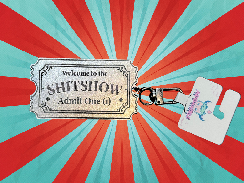 Adorrible Shitshow keychain with a colorful, humorous design featuring the phrase "Tickets to Shitshow" on a metal keyring