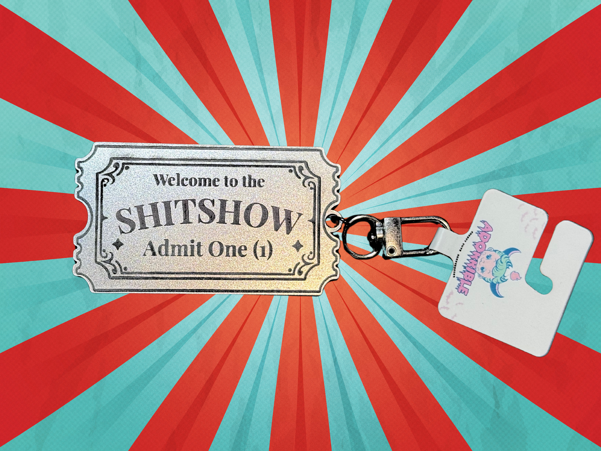Adorrible Shitshow keychain with a colorful, humorous design featuring the phrase "Tickets to Shitshow" on a metal keyring