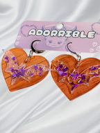 Adorrible Batty Heart earrings featuring heart-shaped design with bat motifs, silver-tone metal, and detailed craftsmanship.