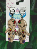 Unique tattoo-inspired Kewpie doll design on trendy clay earrings, perfect for stylish accessory lovers.