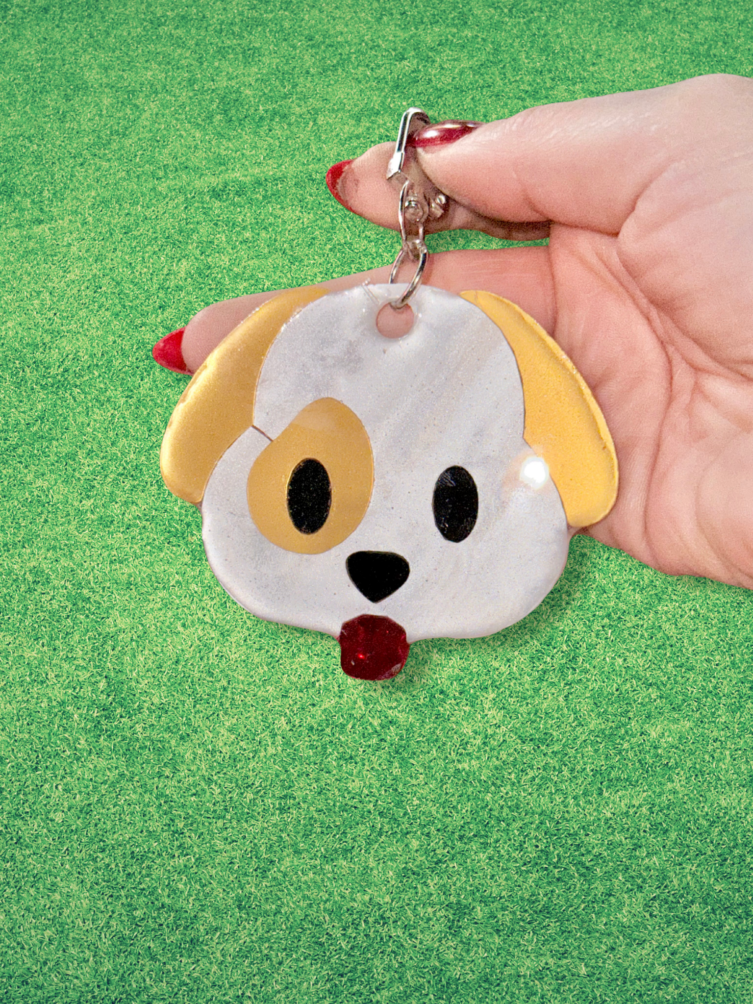 Adorrible Emoji Dog Keychain featuring colorful cartoon dog face with expressive emoji eyes, made of soft rubber material.