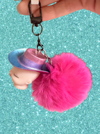 Adorrible Pride cowboy hat baby doll head keychain showing colorful miniature doll face with cowboy hat attachment.