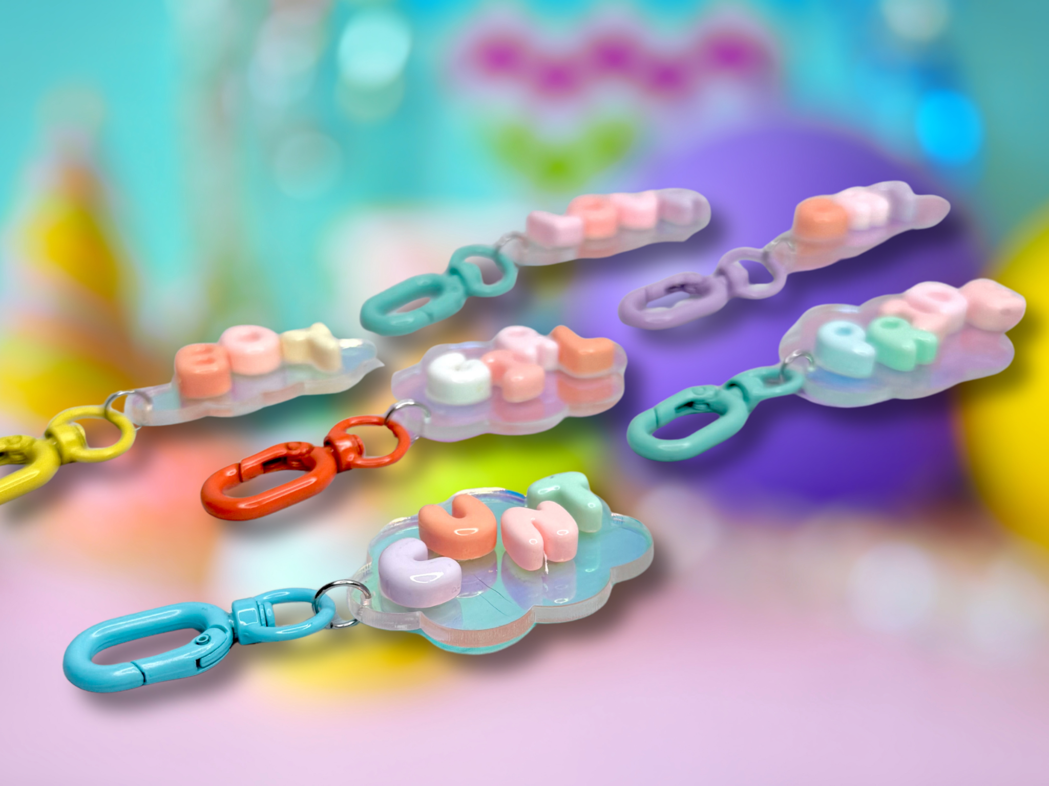Iridescent cloud-shaped bubble letter keychain by Adorrible with metallic finish and playful cloud design.