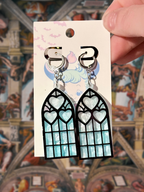 Adorrible Cathedral of Love acrylic dangle earrings featuring intricate geometric design on a neutral background.