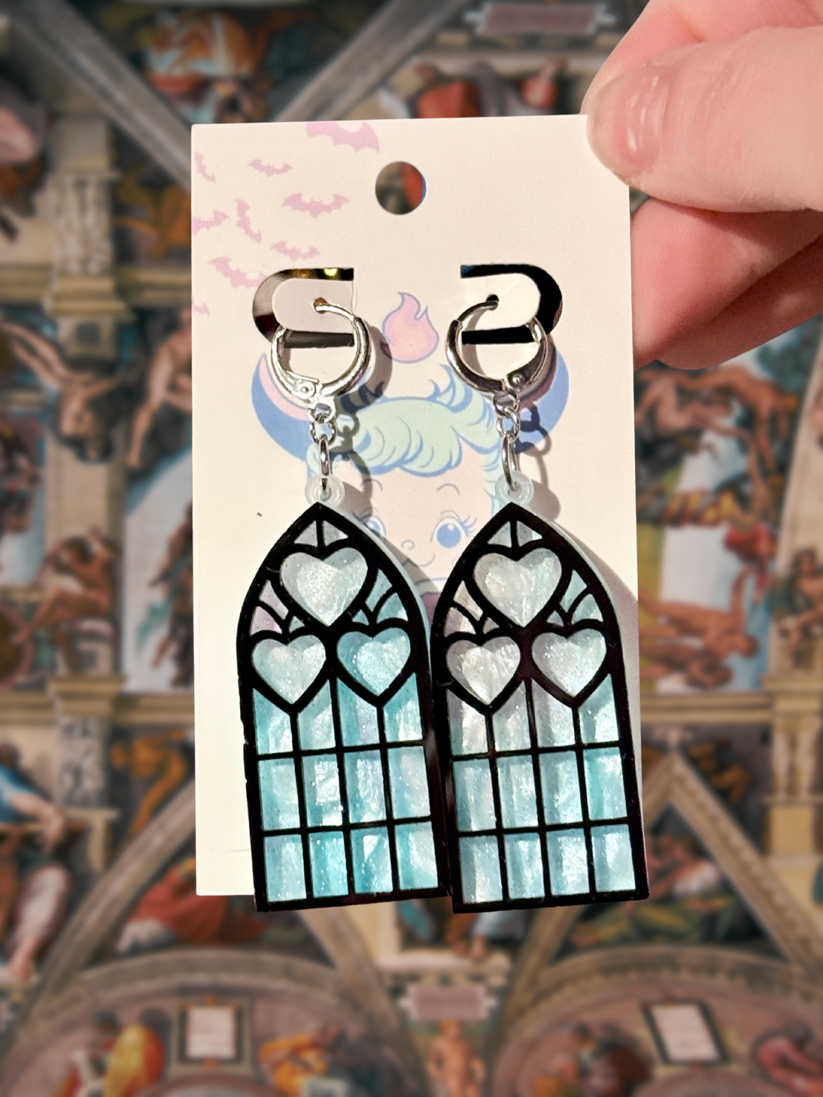 Adorrible Cathedral of Love acrylic dangle earrings featuring intricate geometric design on a neutral background.