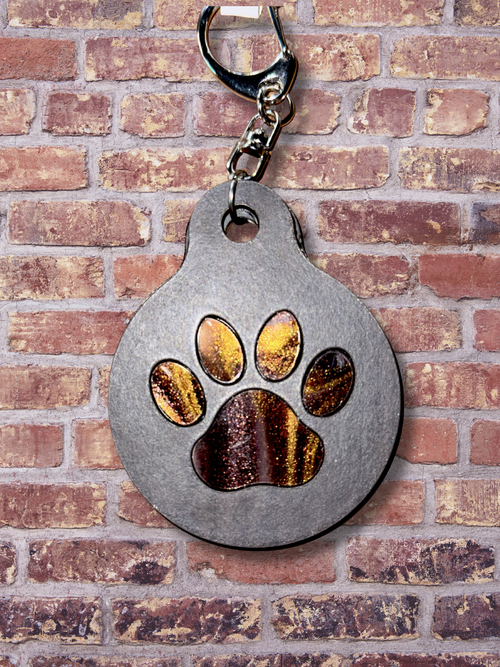 Adorrible paw keychain featuring a cute, detailed paw print design on a metal keyring.