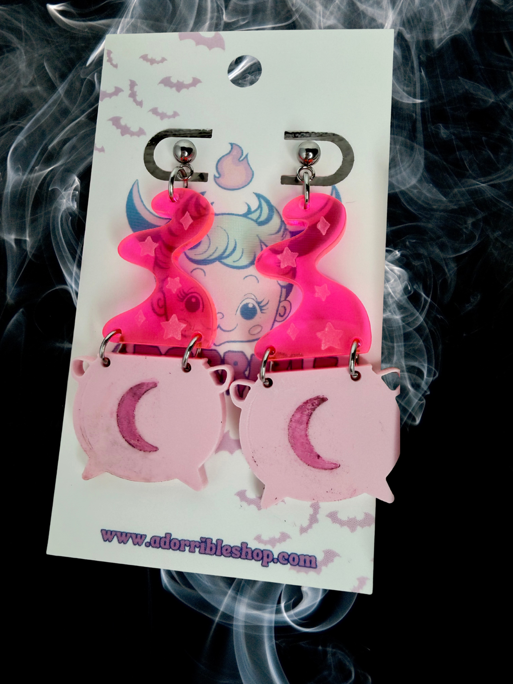 Adorrible witch’s cauldron earrings featuring small black cauldrons with silver handles, dangling from hooks.
