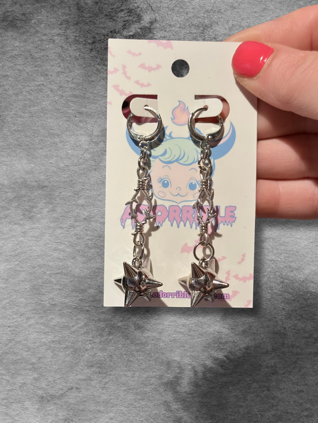 Adorrible metal mace dangle earrings with intricate design and hanging mace-shaped charms on a white background