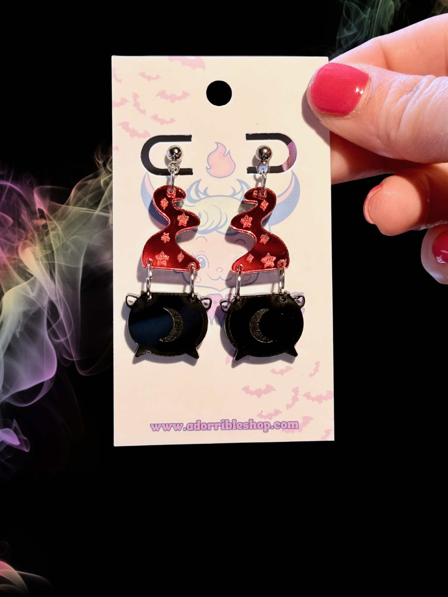 Mini Witch’s Cauldron Earrings by Adorrible featuring small black cauldron charms with silver hooks for Halloween or witch-themed jewelry.