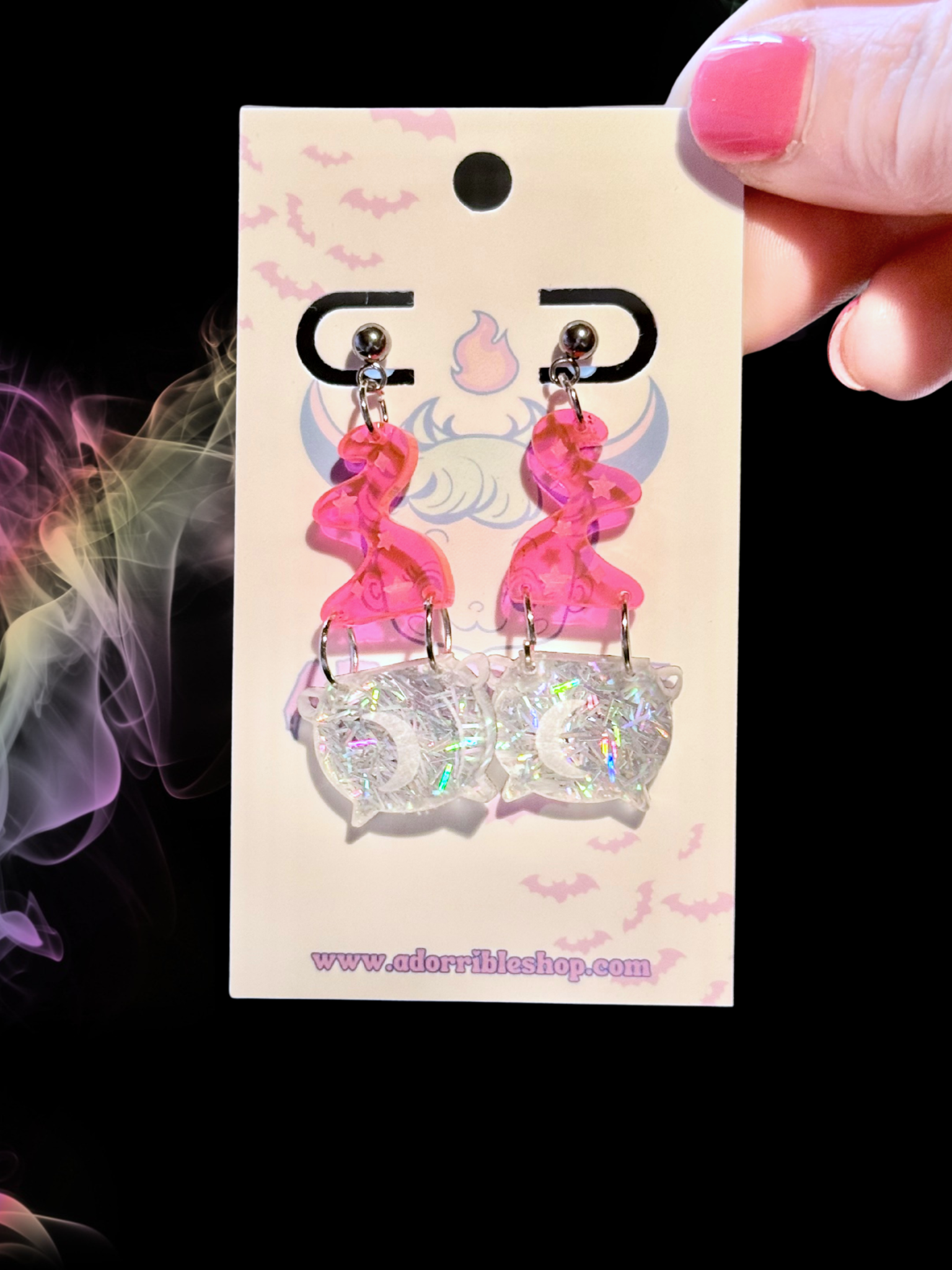 Mini black witch’s cauldron earrings by Adorrible, featuring tiny cauldron charms with detailed handles and bubbling pot designs.