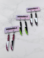 Layered bloody knife dangle earrings by Adorrible featuring dagger-shaped design with layered metal details.
