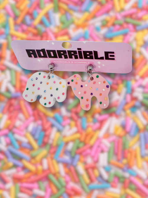 Adorrible animal cookies dangle earrings featuring colorful cookie-shaped charms hanging from silver hooks.